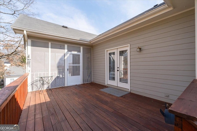 deck with a sunroom and french doors