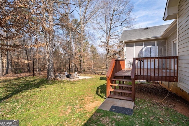 view of yard with an outdoor fire pit, a fenced backyard, a wooden deck, and stairs