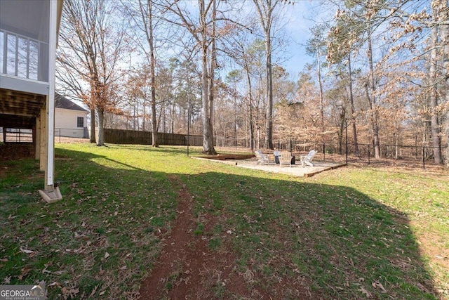 view of yard featuring an outdoor fire pit, a patio area, and a fenced backyard