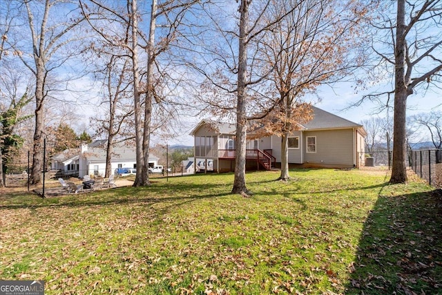 view of yard with fence and stairway