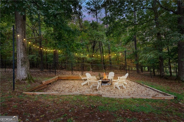 view of yard featuring a fire pit and a fenced backyard