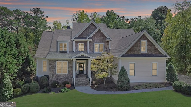 craftsman house with a lawn