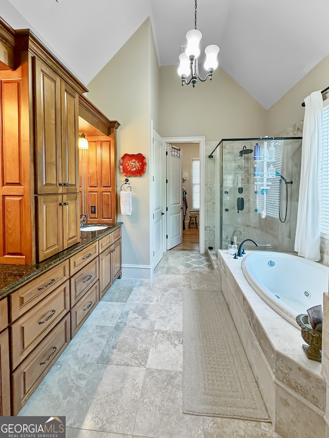 bathroom featuring independent shower and bath, vanity, a chandelier, and high vaulted ceiling