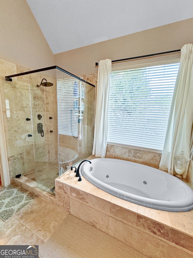 bathroom with plus walk in shower, tile patterned flooring, and a textured ceiling