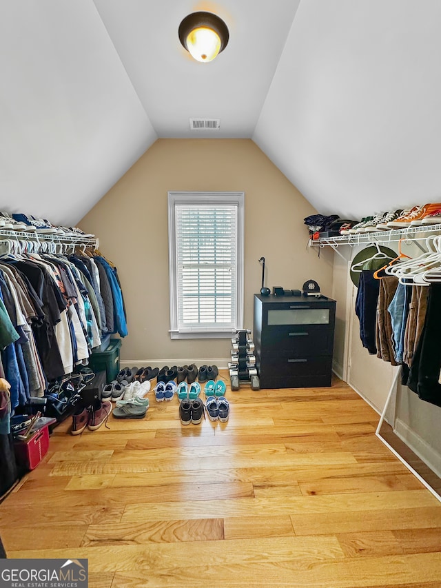 walk in closet featuring vaulted ceiling and hardwood / wood-style flooring