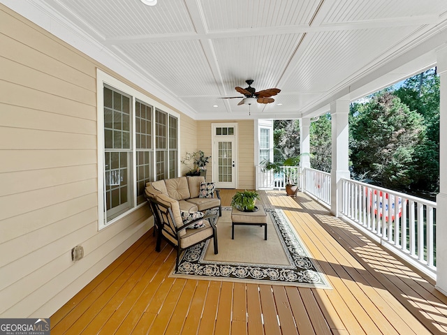 deck featuring ceiling fan and an outdoor living space