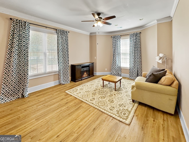 living room featuring ornamental molding, ceiling fan, and hardwood / wood-style floors