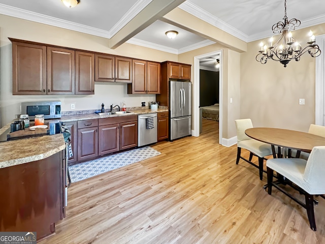 kitchen with appliances with stainless steel finishes, crown molding, light hardwood / wood-style flooring, decorative light fixtures, and sink