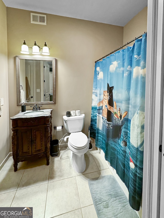 bathroom with vanity, toilet, a shower with shower curtain, and tile patterned floors