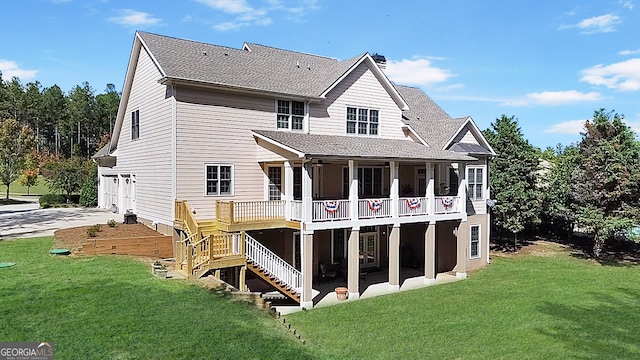 rear view of property featuring a wooden deck and a yard