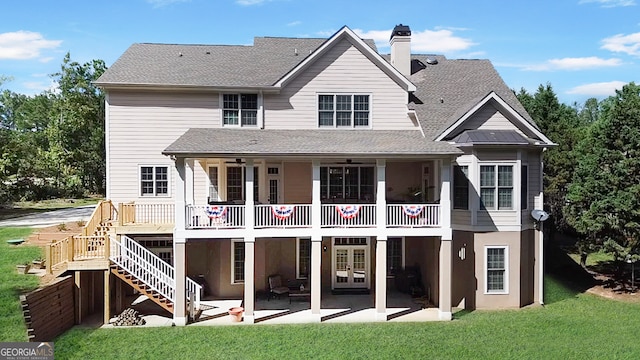 back of house with a yard and a patio area