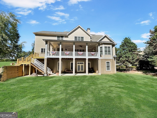 rear view of house with a lawn, ceiling fan, a patio area, and a deck