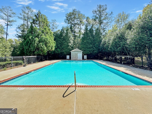 view of swimming pool with an outdoor structure