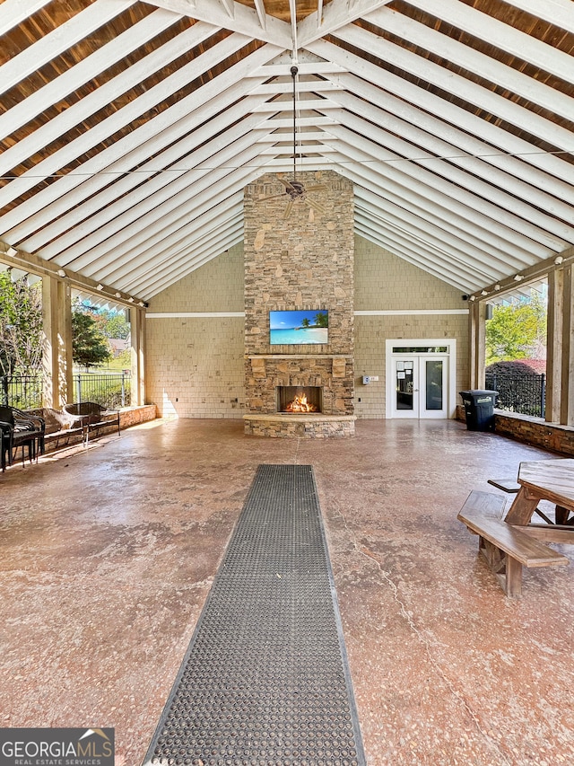 unfurnished living room featuring high vaulted ceiling and plenty of natural light