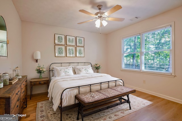 bedroom with ceiling fan and light hardwood / wood-style flooring