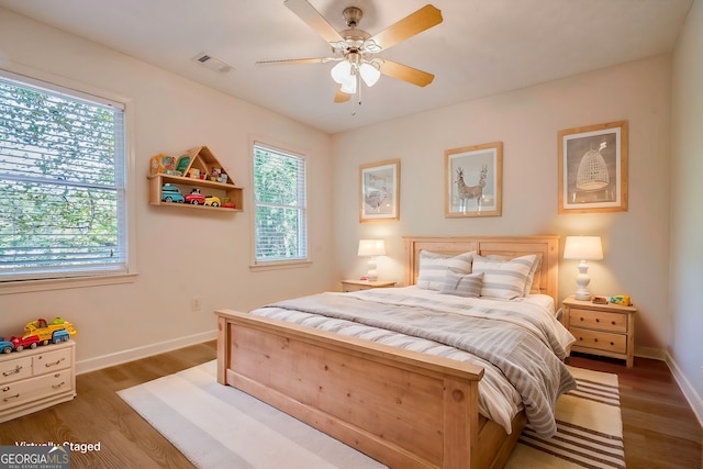 bedroom with ceiling fan and dark wood-type flooring