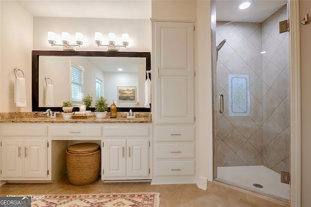 bathroom with vanity, tile patterned floors, and a shower with door