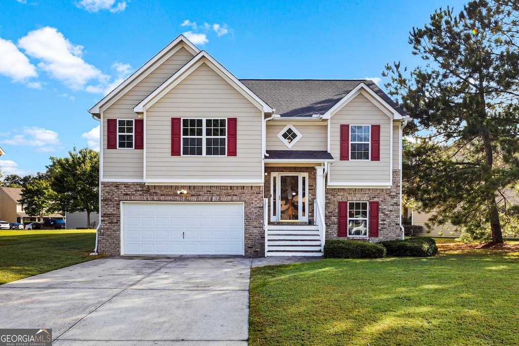 split foyer home featuring a garage and a front lawn