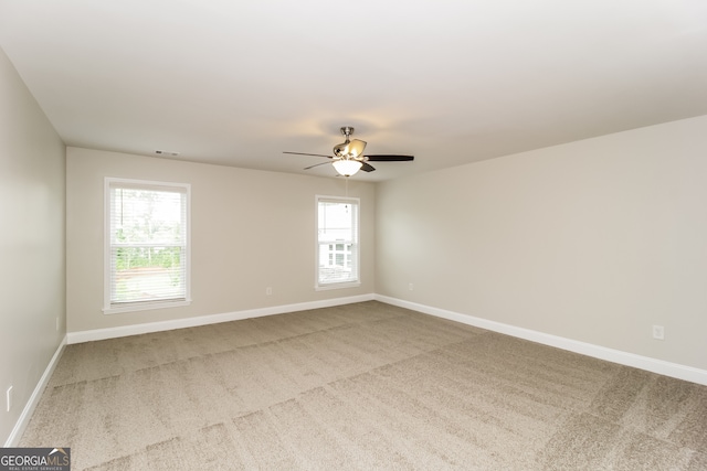 carpeted empty room with ceiling fan