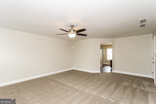 carpeted spare room featuring ceiling fan