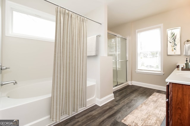 bathroom featuring hardwood / wood-style floors, vanity, and separate shower and tub