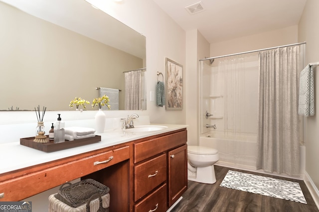 full bathroom featuring shower / tub combo with curtain, hardwood / wood-style flooring, vanity, and toilet