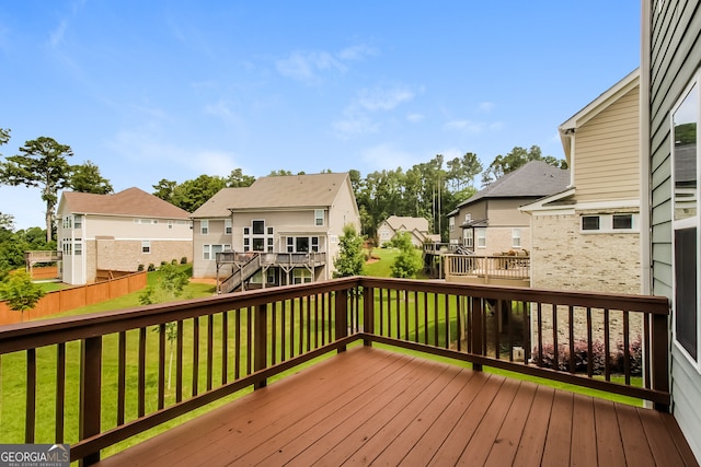 wooden terrace with a lawn