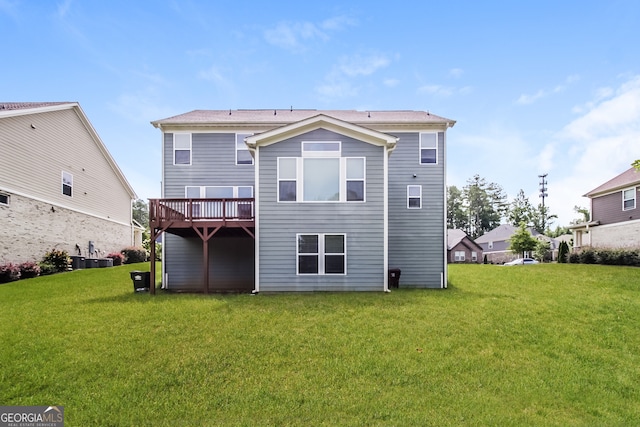 back of house with a lawn and a deck