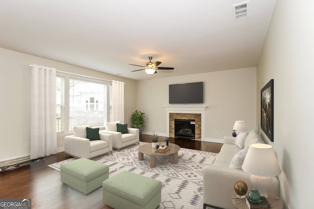 living room featuring ceiling fan and hardwood / wood-style flooring