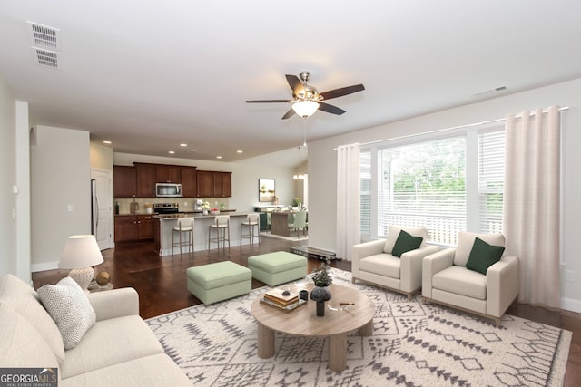 living room with ceiling fan and hardwood / wood-style flooring