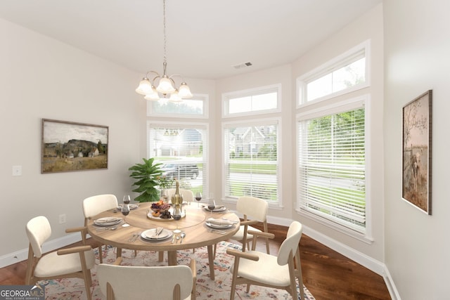 dining area featuring wood-type flooring and a notable chandelier