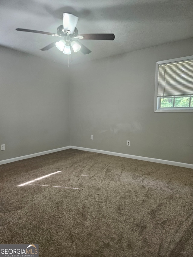 empty room featuring carpet flooring and ceiling fan