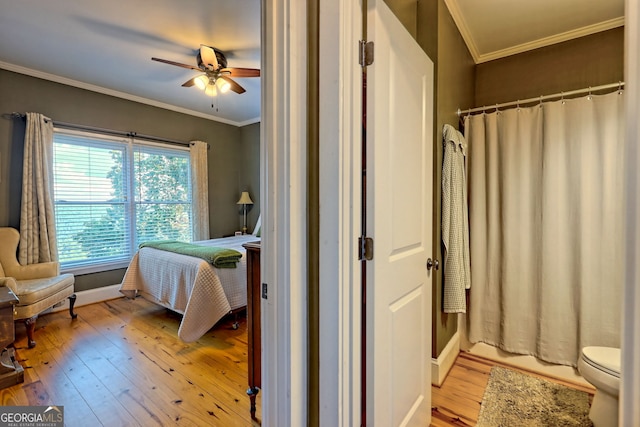 bedroom with ornamental molding, ceiling fan, and light hardwood / wood-style flooring