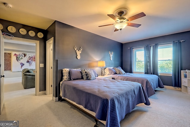 bedroom featuring light carpet and ceiling fan