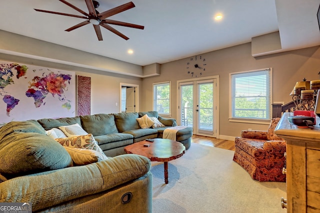 living room featuring ceiling fan and light hardwood / wood-style flooring