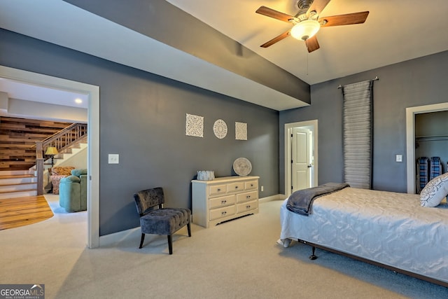 bedroom with wood walls, ceiling fan, and carpet flooring