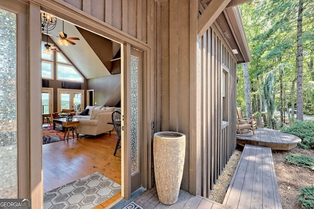 entrance to property with a deck and ceiling fan