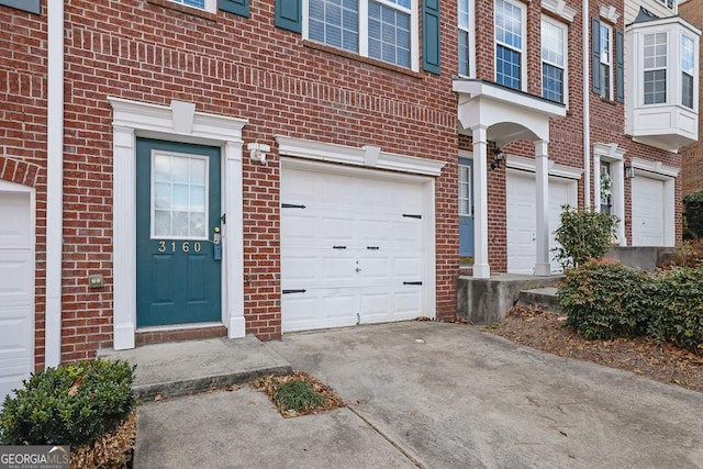 townhome / multi-family property with a garage