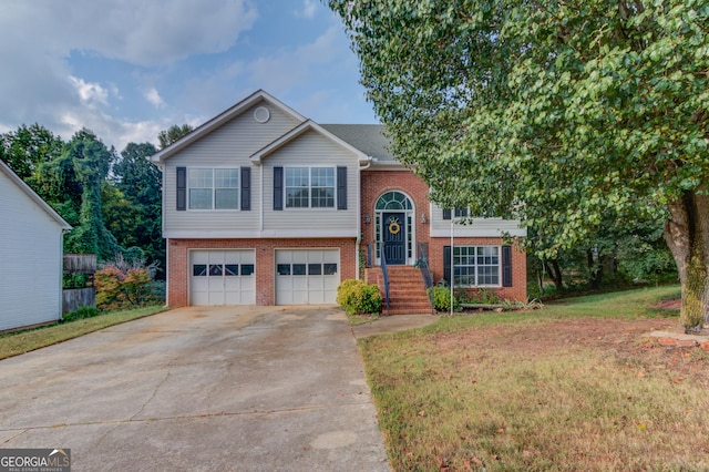 split foyer home featuring a front yard and a garage