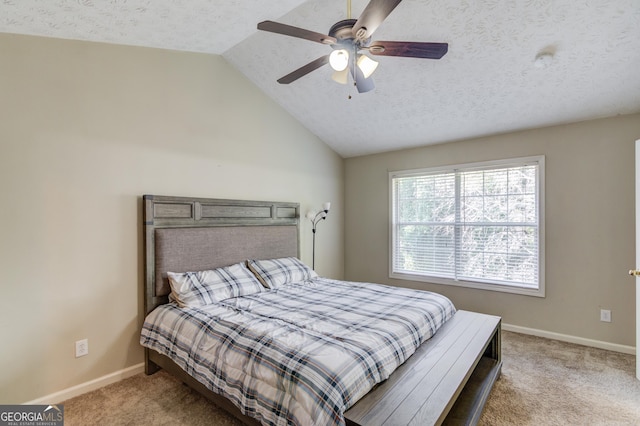 carpeted bedroom featuring ceiling fan, lofted ceiling, and a textured ceiling