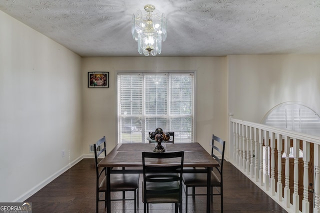 dining space with a textured ceiling and dark hardwood / wood-style floors