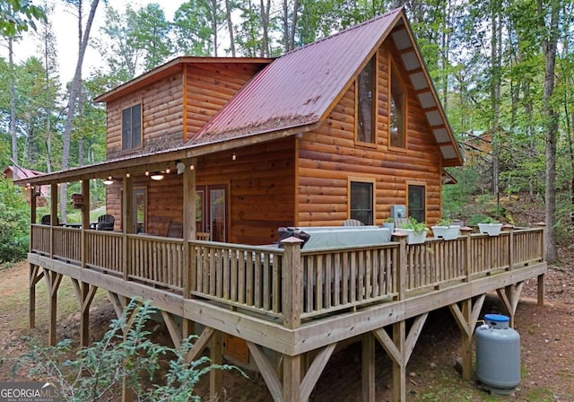 back of property with a wooden deck