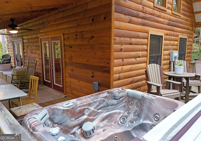 bedroom with rustic walls, hardwood / wood-style floors, and multiple windows