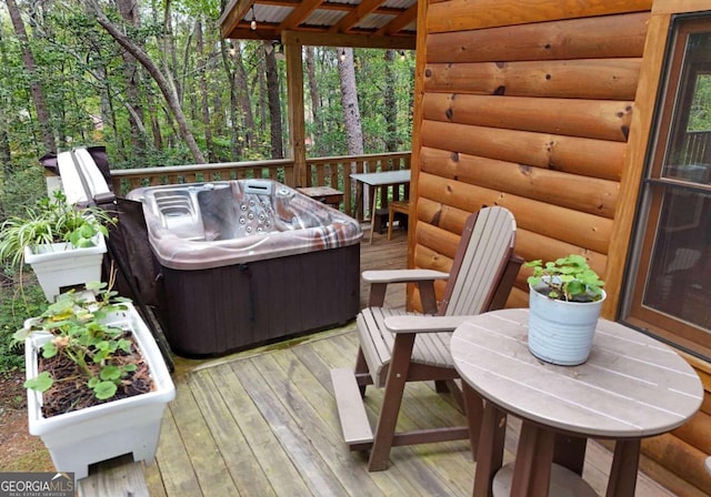 wooden deck with a hot tub