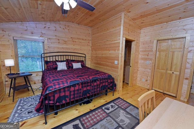 bedroom with ceiling fan, hardwood / wood-style flooring, and vaulted ceiling