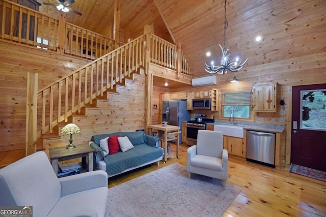 living room with high vaulted ceiling, light wood-type flooring, wooden walls, and sink