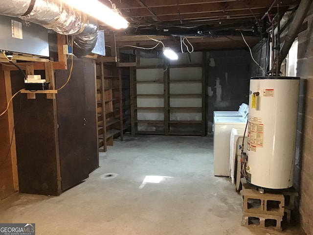 basement with washing machine and dryer and water heater