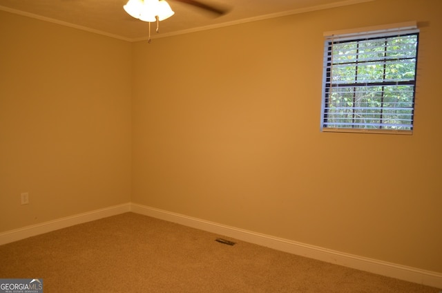 spare room with ornamental molding, ceiling fan, and carpet floors