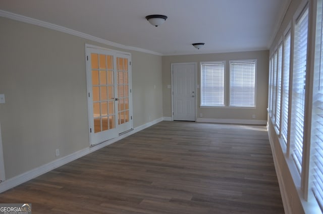 unfurnished room with ornamental molding and dark wood-type flooring