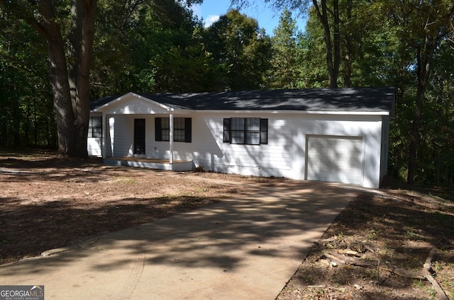 single story home featuring covered porch and a garage